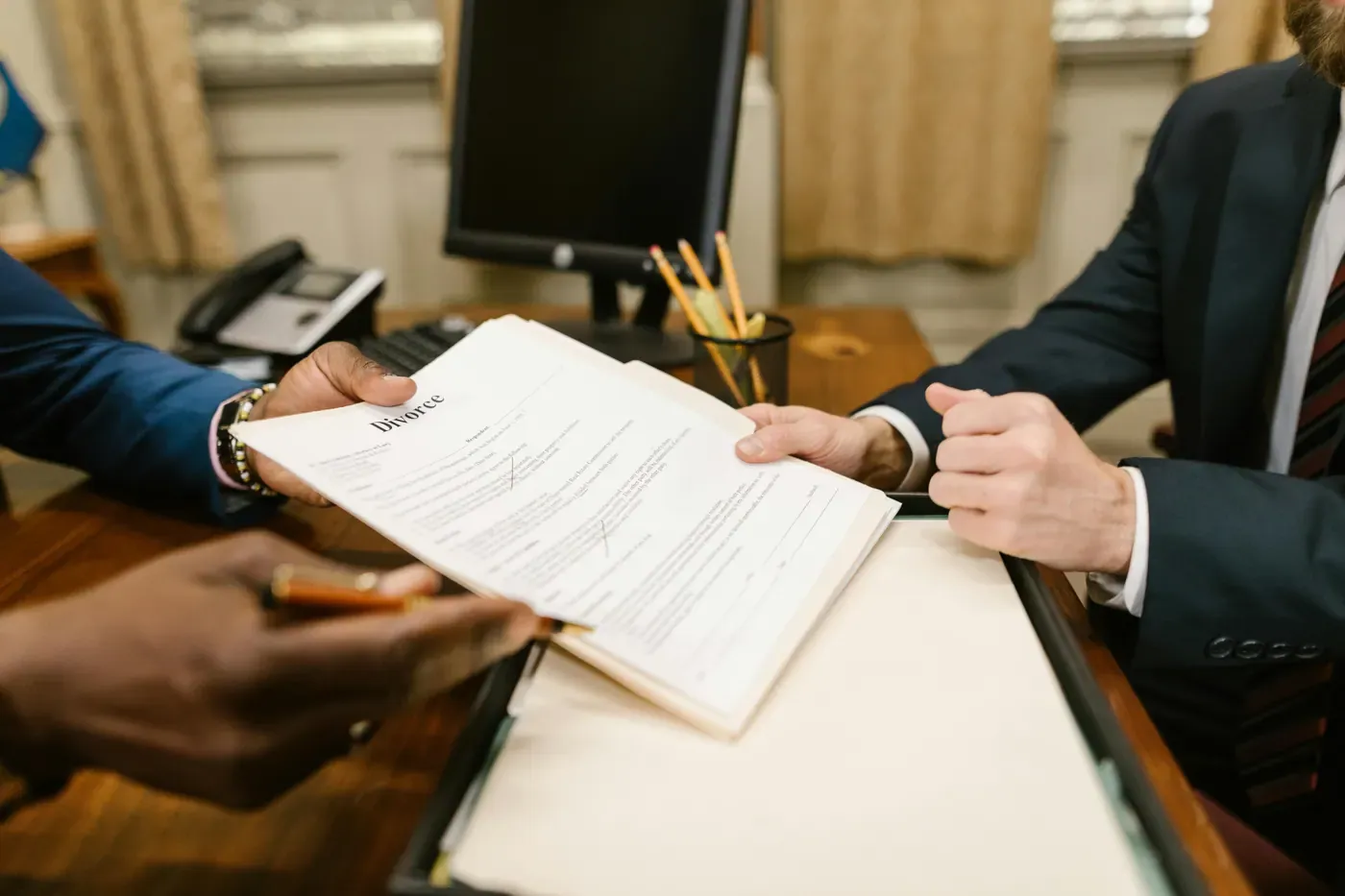 Legal papers handoff across desk