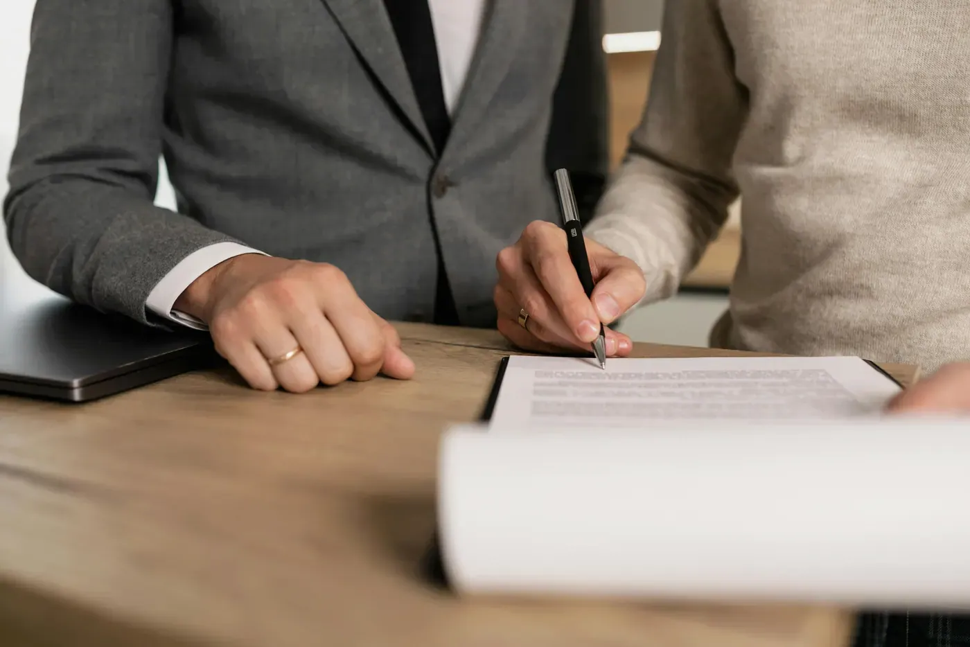 Couple signing documents with a mobile notary