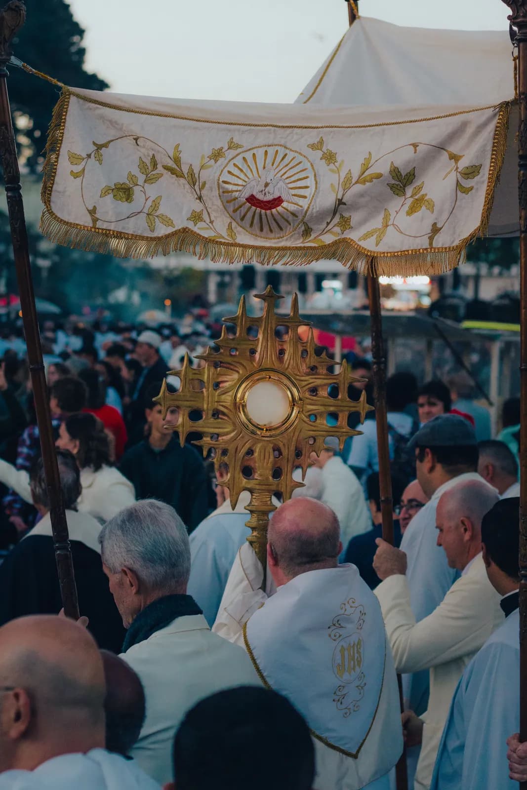 A eucharistic procession, the faithful gathered behind the monstrance.
