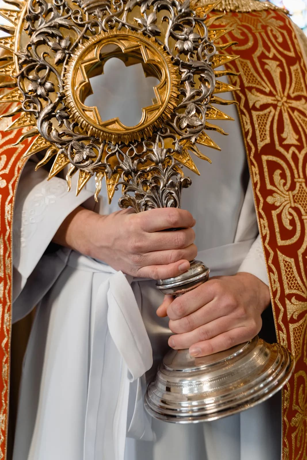 A golden monstrance held high during eucharistic adoration.