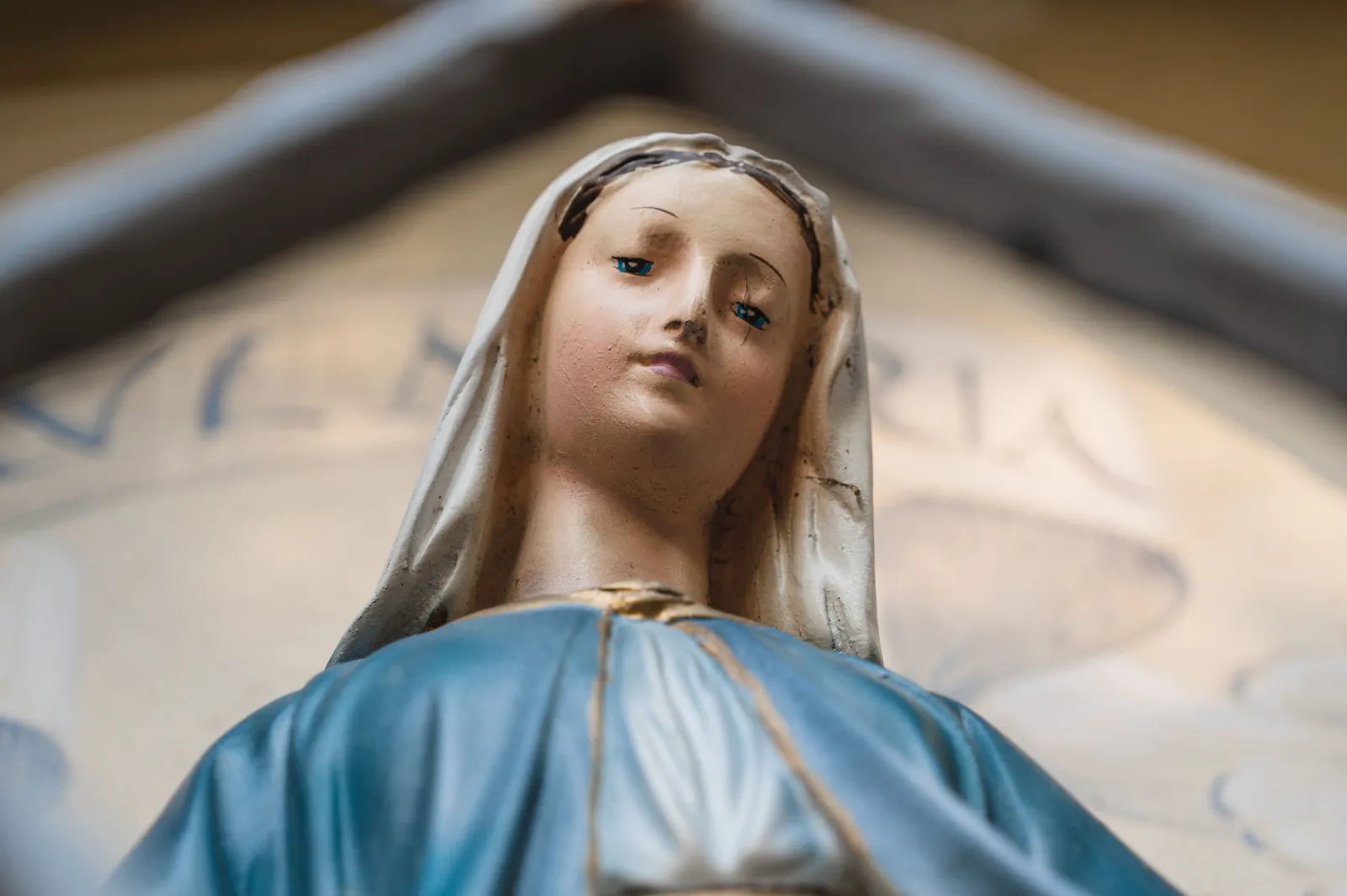 A statue of the Blessed Virgin Mary in a blue mantle.